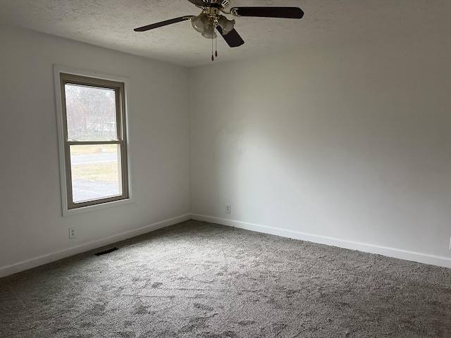 unfurnished room with ceiling fan, carpet floors, and a textured ceiling