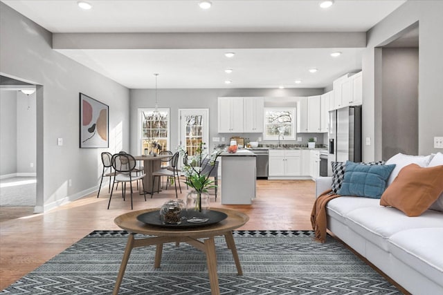 living area featuring recessed lighting, wood finished floors, and baseboards