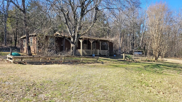 exterior space with covered porch and a front lawn