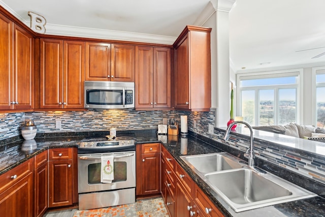 kitchen with dark stone counters, sink, stainless steel appliances, and backsplash