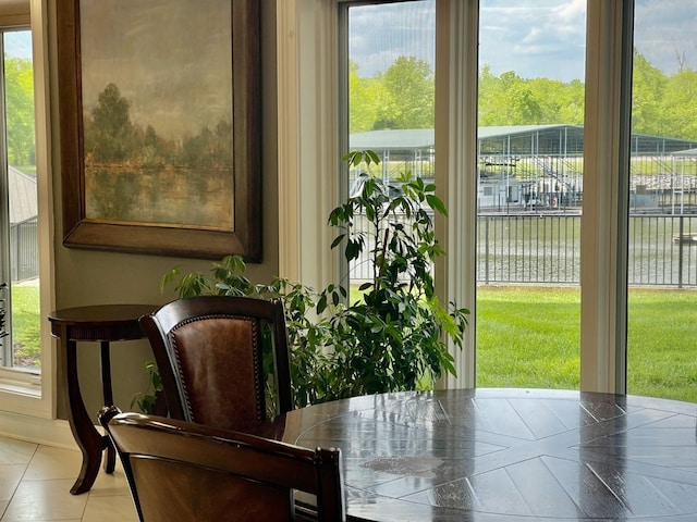 interior space with a water view and light tile patterned flooring