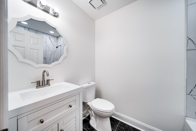 bathroom with vanity, toilet, and a shower