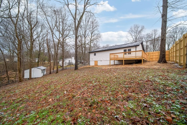 view of yard with a deck and a storage shed