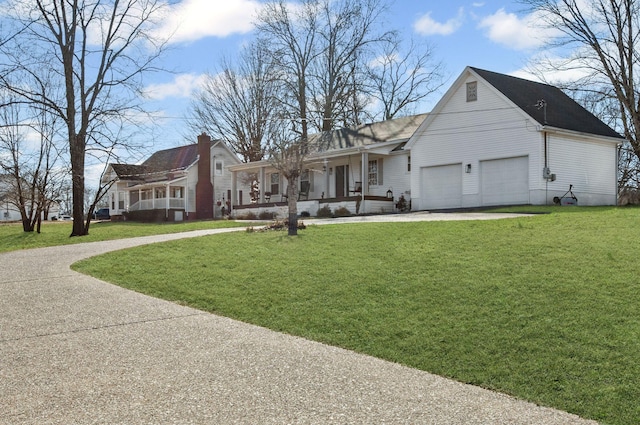 view of front of house with a front lawn, covered porch, and driveway