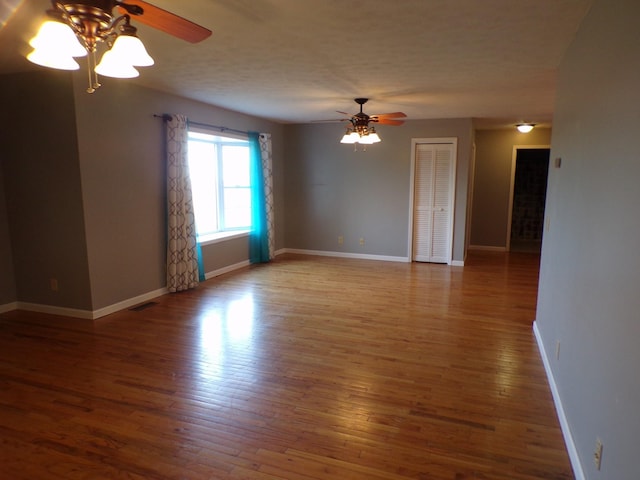 unfurnished room with hardwood / wood-style flooring, ceiling fan, and a textured ceiling