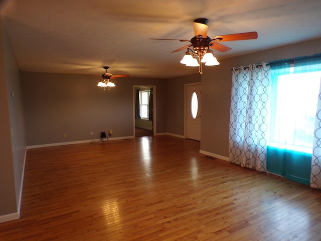 unfurnished living room featuring ceiling fan and wood-type flooring