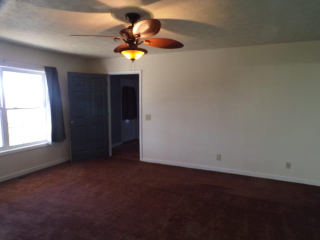 spare room with carpet floors and ceiling fan