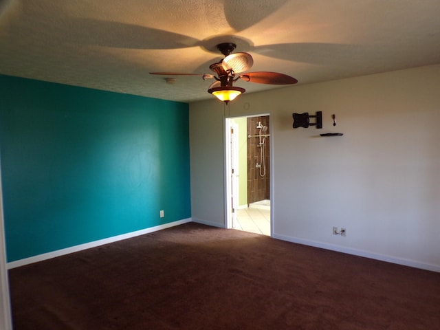 carpeted empty room featuring ceiling fan and a textured ceiling