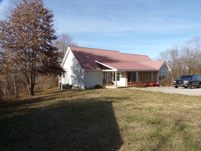 view of front of home featuring cooling unit, a front yard, and a porch