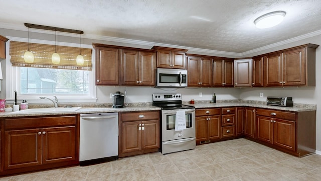 kitchen with brown cabinetry, ornamental molding, decorative light fixtures, stainless steel appliances, and a sink