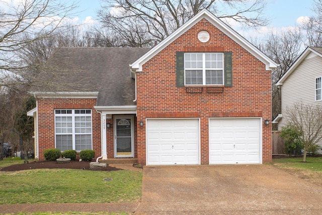 traditional-style home featuring brick siding, a shingled roof, an attached garage, a front yard, and driveway