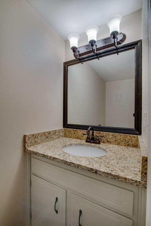 bathroom with vanity and an inviting chandelier