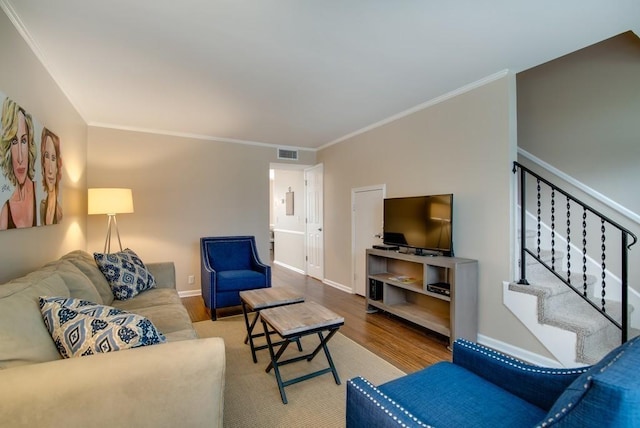 living room with hardwood / wood-style flooring and ornamental molding