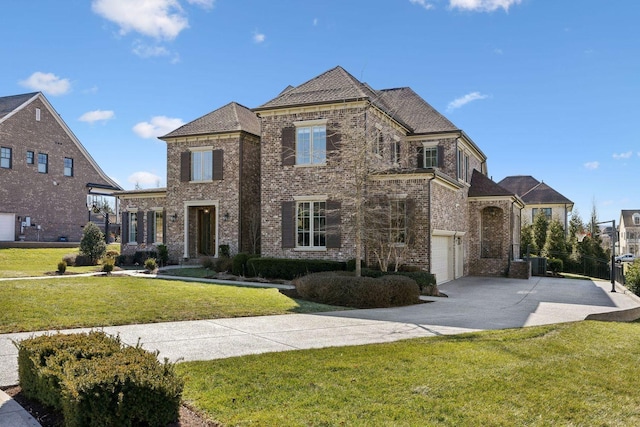 view of front of home with driveway, an attached garage, a front lawn, and brick siding