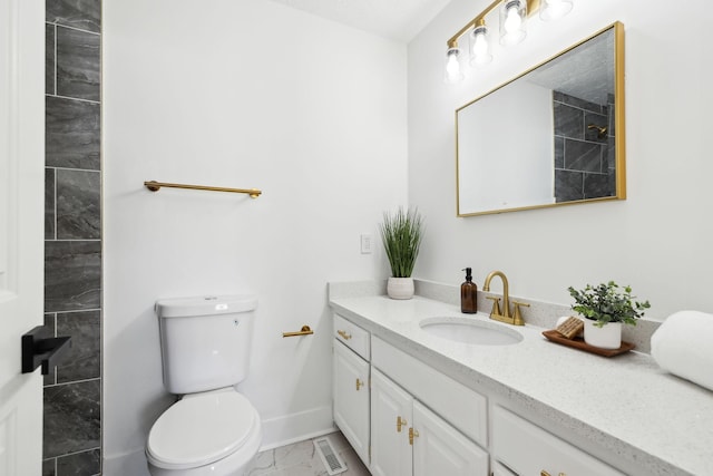 full bath featuring toilet, visible vents, vanity, baseboards, and marble finish floor