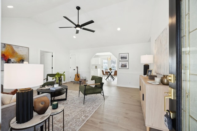 living room featuring arched walkways, recessed lighting, ceiling fan, light wood-type flooring, and baseboards