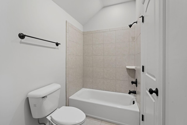 bathroom featuring tiled shower / bath combo, toilet, tile patterned floors, and lofted ceiling