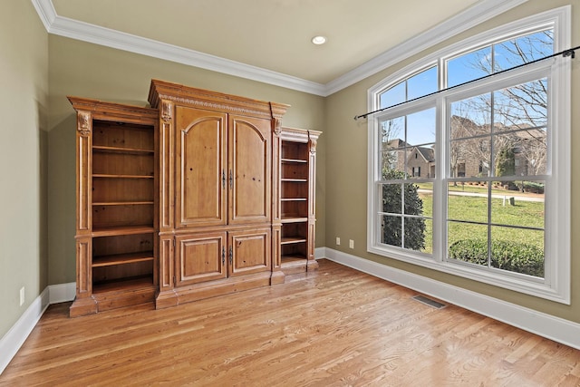 unfurnished bedroom featuring ornamental molding and light hardwood / wood-style flooring