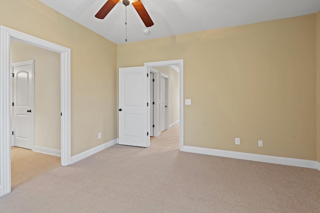 unfurnished bedroom featuring light carpet and ceiling fan