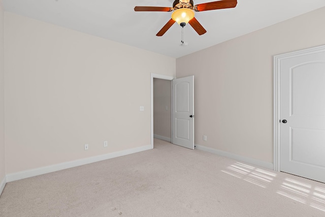 empty room with light carpet and ceiling fan