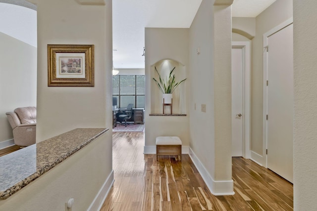 corridor featuring wood-type flooring