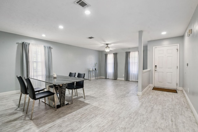 dining space with ceiling fan and light wood-type flooring