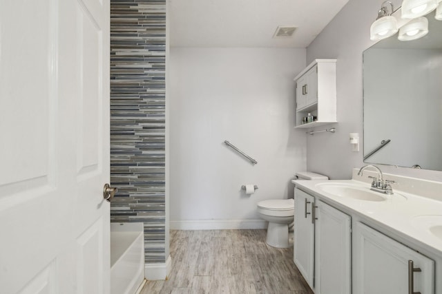 full bathroom featuring toilet, wood-type flooring, vanity, and independent shower and bath