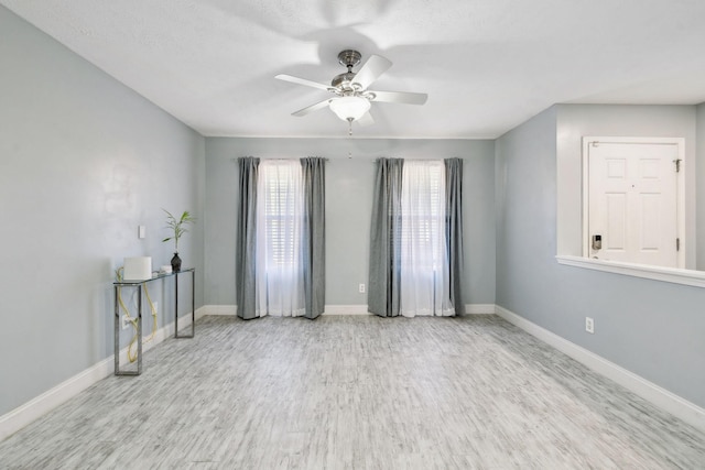 spare room featuring ceiling fan and light hardwood / wood-style floors