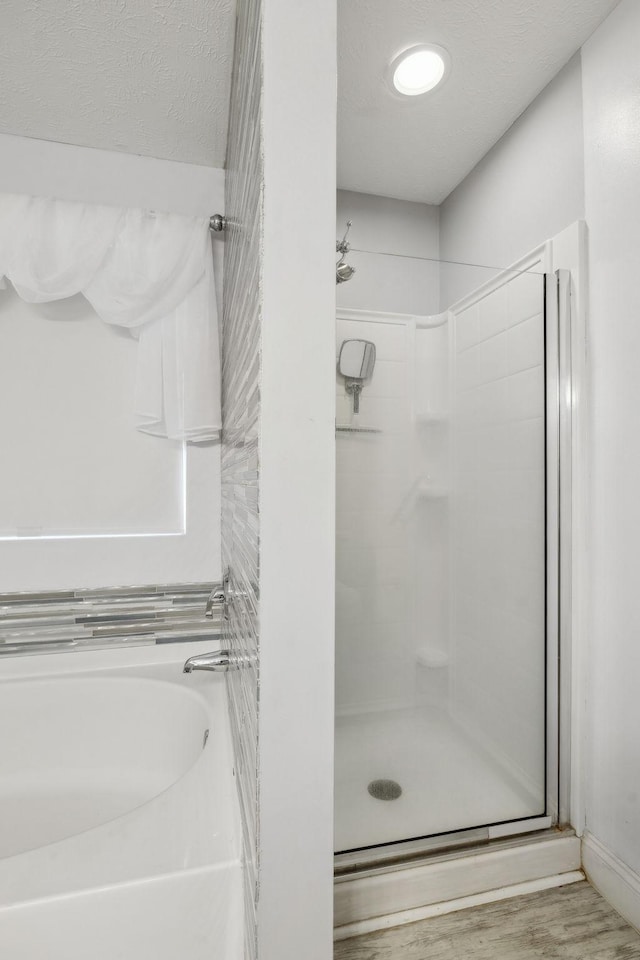 bathroom featuring hardwood / wood-style flooring and a shower with door