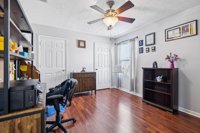 office with ceiling fan, dark hardwood / wood-style flooring, and a textured ceiling