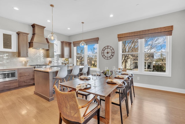 dining room featuring sink and light hardwood / wood-style flooring