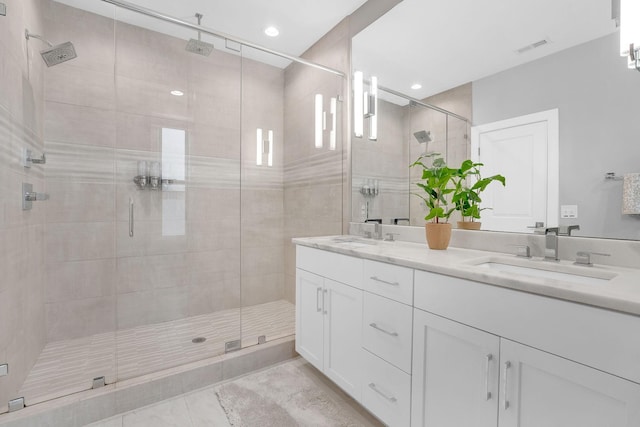 bathroom with tile patterned floors, a shower with shower door, and vanity