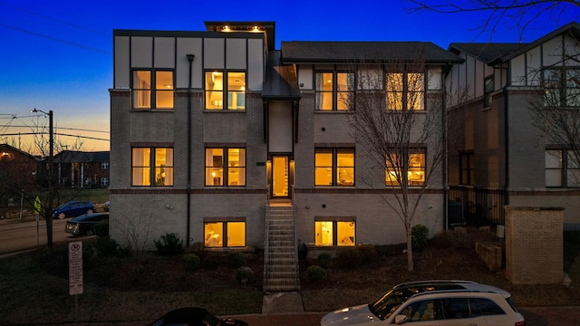 view of back house at dusk