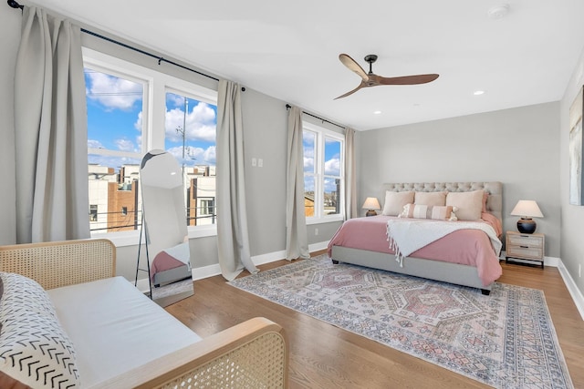 bedroom featuring access to exterior, ceiling fan, and wood-type flooring