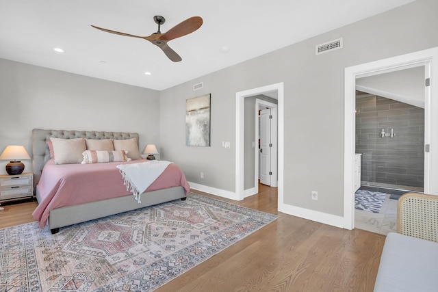 bedroom featuring connected bathroom, hardwood / wood-style flooring, and ceiling fan