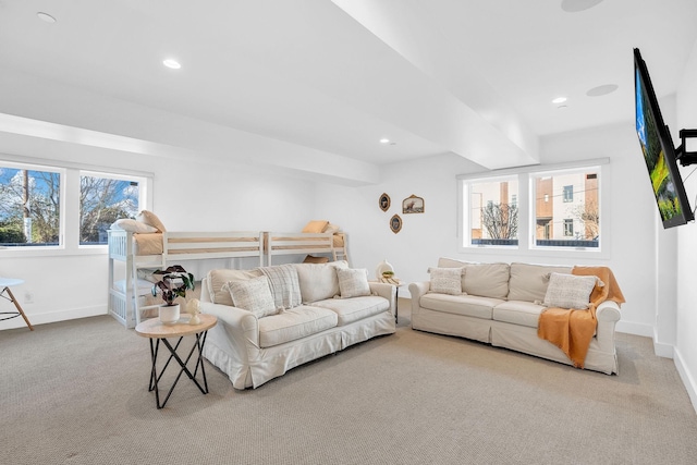 living room featuring light colored carpet and beam ceiling