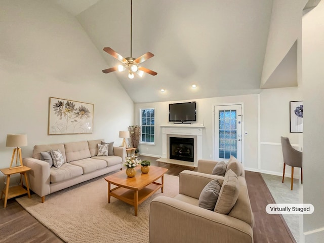 living room featuring ceiling fan, high vaulted ceiling, and wood-type flooring