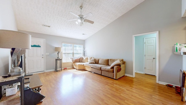 living room featuring light wood-type flooring, high vaulted ceiling, a textured ceiling, and ceiling fan