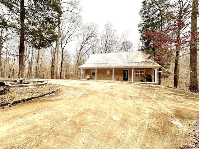 view of front of home with a porch and metal roof