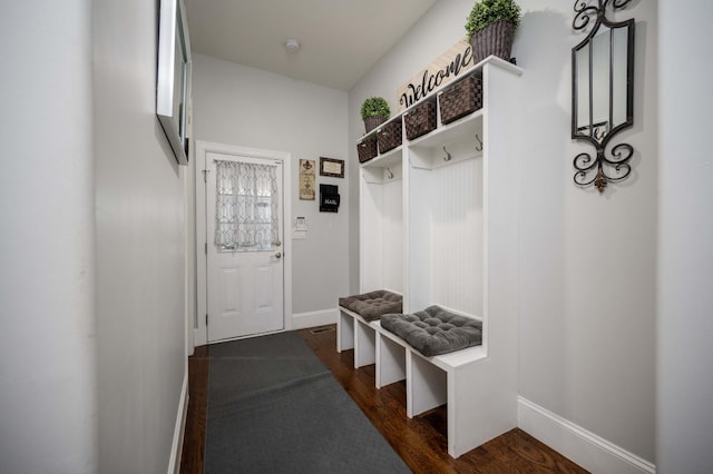 mudroom featuring dark wood-style floors and baseboards