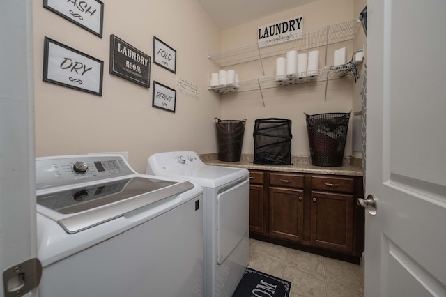 clothes washing area with washer and dryer and cabinet space