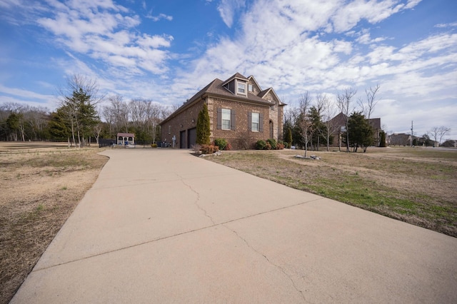 view of front of property with concrete driveway and brick siding