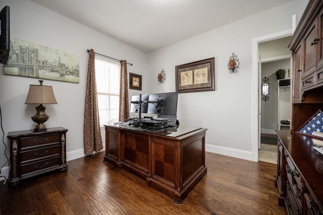 office space with dark wood finished floors and baseboards