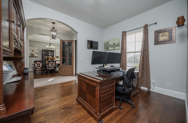 office space featuring arched walkways, dark wood-style flooring, baseboards, and a notable chandelier