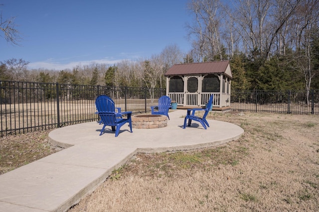 exterior space featuring a patio area, fence, a fire pit, and a gazebo