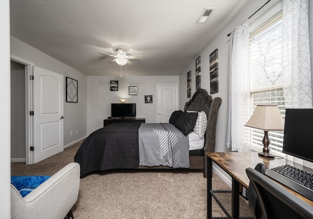 bedroom with carpet floors, visible vents, baseboards, and a ceiling fan