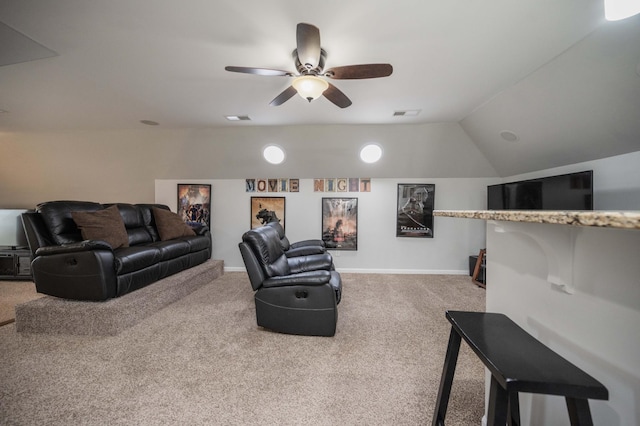 living area featuring carpet floors, visible vents, a ceiling fan, vaulted ceiling, and baseboards