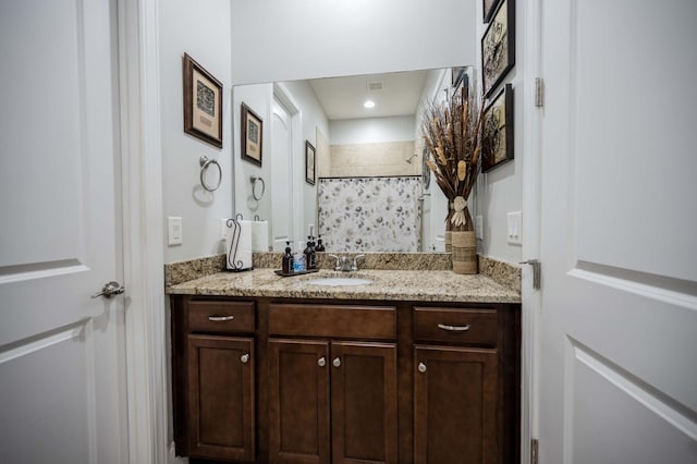 full bath with curtained shower and vanity