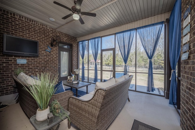 sunroom / solarium featuring ceiling fan and wooden ceiling