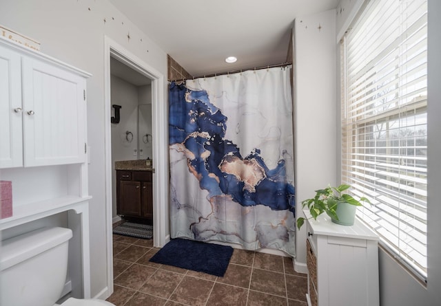 full bath featuring tile patterned flooring, curtained shower, vanity, and toilet